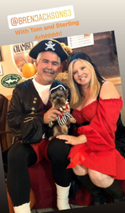 Couple and dog all dressed as pirates.